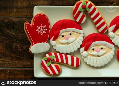 Delicious Christmas cookies in red tone on a wooden table