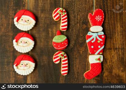 Delicious Christmas cookies in red tone on a wooden table