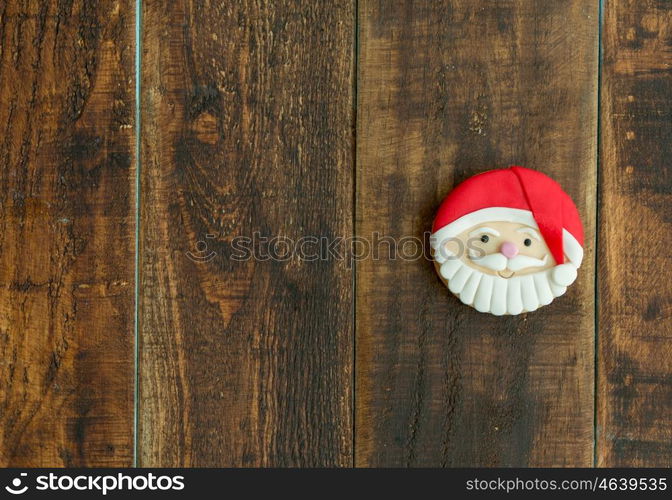 Delicious Christmas cookies with Santa Claus face on a wooden table