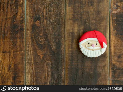 Delicious Christmas cookies with Santa Claus face on a wooden table