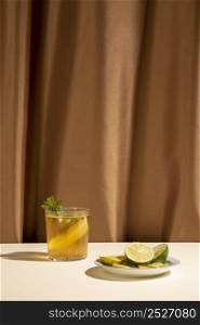 delicious cocktail drink with mint leaves lime slices table front brown curtain