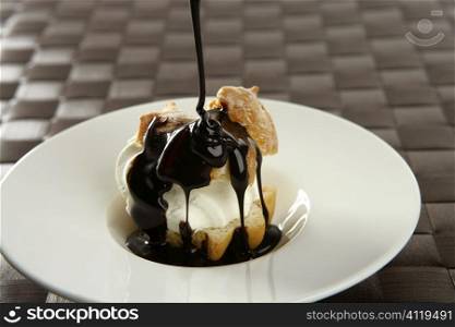 Delicious cream puff cake with chocolate syrup