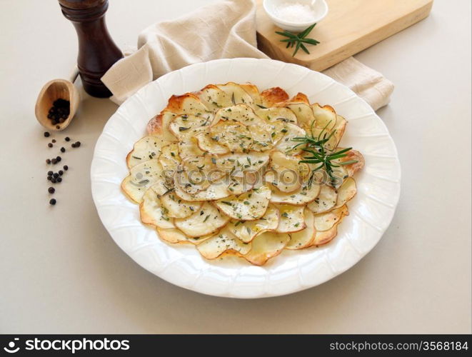 Delicious crispy baked potato chips with rosemary ready to serve.