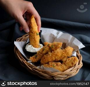 Delicious crispy fried breaded chicken breast with sour cream