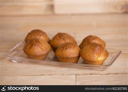Delicious cupcakes on wooden table