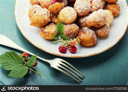 Delicious curd donuts with raspberries.Donuts on a plate.Delicacy.. Curd donuts with raspberries