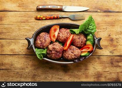 Delicious dietary veal cutlets. Steam meatballs and sliced vegetables. Steam beef cutlets