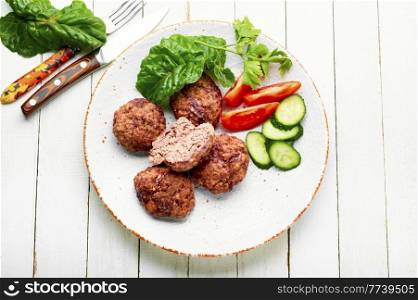 Delicious dietary veal meatballs. Steam cutlets and sliced vegetables. Steam beef meatballs