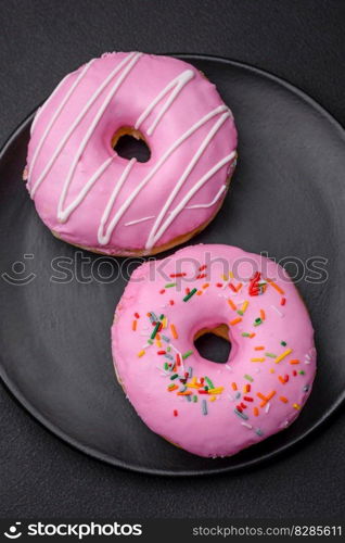 Delicious donut with cream filling and nuts on a dark concrete background. Sweet junk food