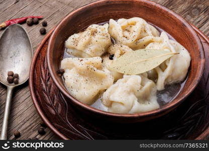 Delicious dumplings in the bowl on the table.Asian dumplings in bowl. Fresh boiled dumplings