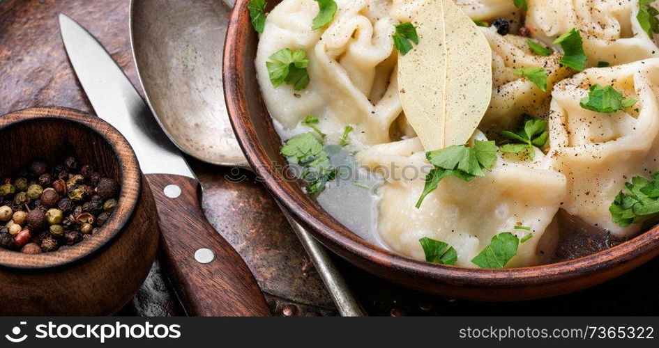 Delicious dumplings in the bowl on the table.Chinese dumplings for dinner. Homemade dumplings in bowl