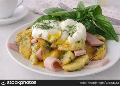 Delicious eggs benedict with fried potatoes and bacon for breakfast.