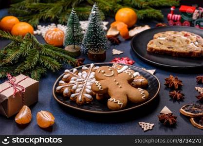 Delicious festive New Year’s pie with candied fruits, marzipan and nuts on a dark concrete background. Preparation of the festive table. Delicious festive New Year’s pie with candied fruits, marzipan and nuts on a dark concrete background
