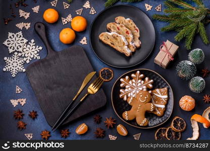 Delicious festive New Year’s pie with candied fruits, marzipan and nuts on a dark concrete background. Preparation of the festive table. Delicious festive New Year’s pie with candied fruits, marzipan and nuts on a dark concrete background