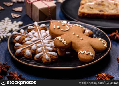 Delicious festive New Year’s pie with candied fruits, marzipan and nuts on a dark concrete background. Preparation of the festive table. Delicious festive New Year’s pie with candied fruits, marzipan and nuts on a dark concrete background