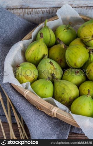Delicious figs on top of wooden kitchen countertop.