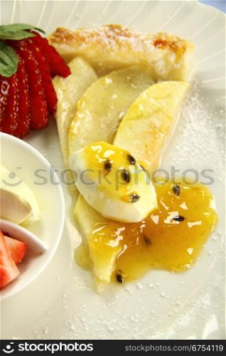 Delicious flat apple pie with strawberries and passionfruit.