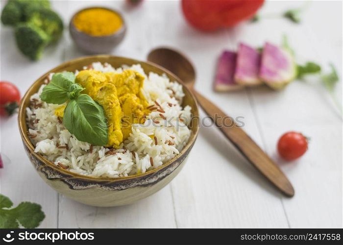 delicious food with chicken bowl near spoon ingredients white table
