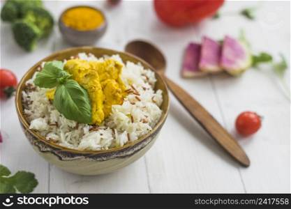 delicious food with chicken bowl near spoon ingredients white table
