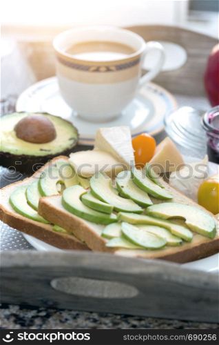 delicious French breakfast. a cup of coffee and avocado sandwiches