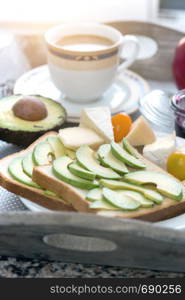 delicious French breakfast. a cup of coffee and avocado sandwiches