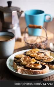 delicious french breakfast - toast with chocolate and fried bananas on wooden background