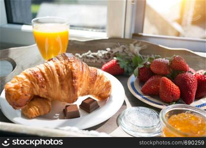 delicious French breakfast with a view of the castle. strawberries and croissants for breakfast