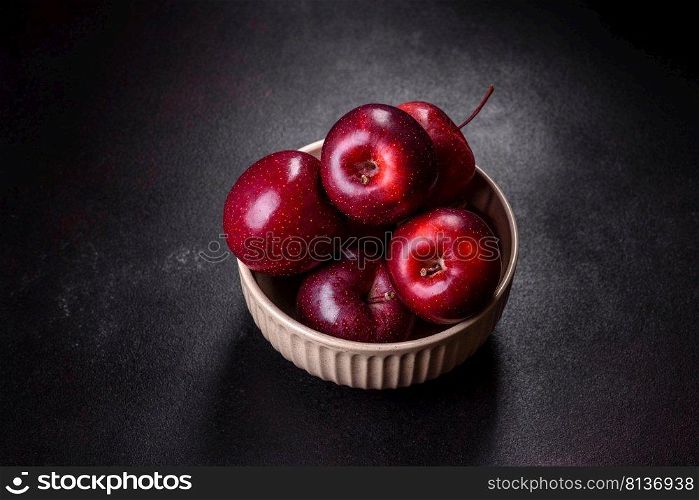 Delicious fresh apples in red on a dark concrete background. Home garden harvest. Delicious fresh apples in red on a dark concrete background