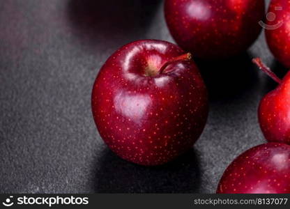 Delicious fresh apples in red on a dark concrete background. Home garden harvest. Delicious fresh apples in red on a dark concrete background