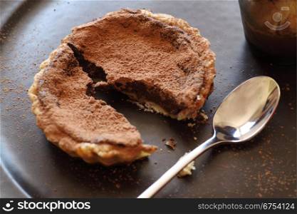 Delicious fresh baked chocolate tart broken ready to serve.