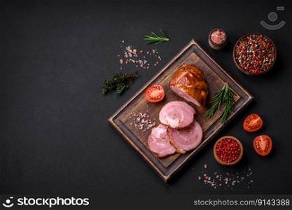 Delicious fresh baked meat roll with spices and herbs on a dark concrete background