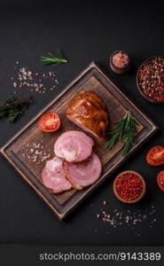 Delicious fresh baked meat roll with spices and herbs on a dark concrete background