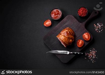 Delicious fresh baked meat roll with spices and herbs on a dark concrete background