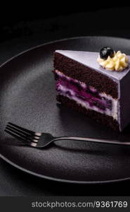 Delicious fresh blueberry or blackcurrant cake with cream cheese on a dark concrete background. Delicious fresh blueberry or blackcurrant cake with cream cheese