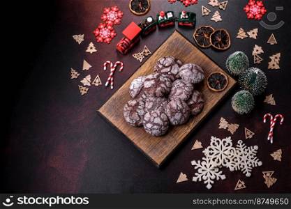 Delicious fresh brownies with Christmas decorations on a dark concrete background. Preparation of the festive table. Delicious fresh brownies with Christmas decorations on a dark concrete background