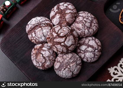 Delicious fresh brownies with Christmas decorations on a dark concrete background. Preparation of the festive table. Delicious fresh brownies with Christmas decorations on a dark concrete background