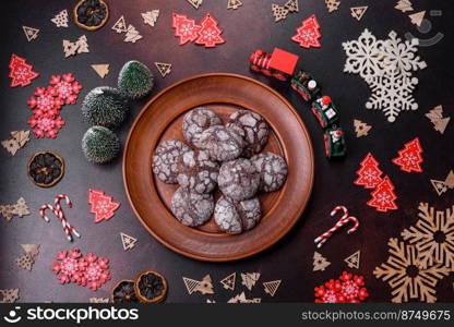 Delicious fresh brownies with Christmas decorations on a dark concrete background. Preparation of the festive table. Delicious fresh brownies with Christmas decorations on a dark concrete background