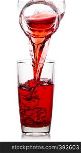 Delicious fresh cherry juice poured into a tall glass with a transparent jug isolated on a white background. Delicious fresh cherry juice poured into tall glass with transpa