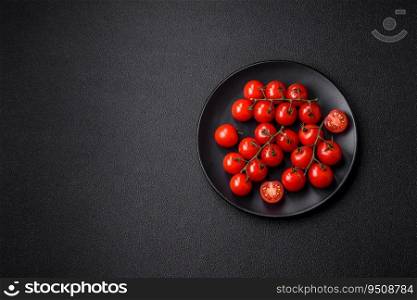 Delicious fresh cherry tomatoes on the branches as an ingredient for cooking a vegetarian dish on a dark concrete background