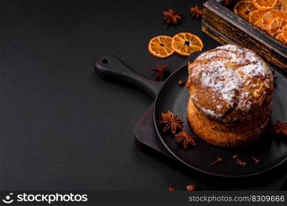 Delicious fresh christmas pie with fruit and raisin panettone on a dark concrete background