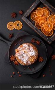 Delicious fresh christmas pie with fruit and raisin panettone on a dark concrete background
