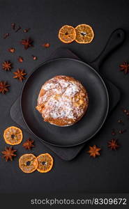 Delicious fresh christmas pie with fruit and raisin panettone on a dark concrete background