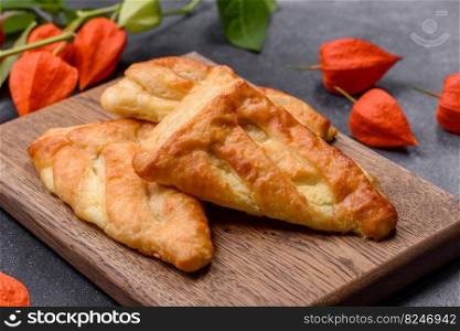 Delicious fresh cornmeal pastries with homemade cheese on a wooden cutting board. Delicious healthy breakfast. Delicious fresh cornmeal pastries with homemade cheese on a wooden cutting board