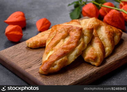 Delicious fresh cornmeal pastries with homemade cheese on a wooden cutting board. Delicious healthy breakfast. Delicious fresh cornmeal pastries with homemade cheese on a wooden cutting board