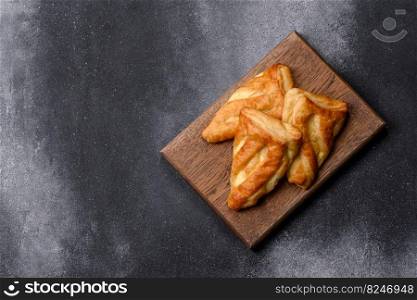 Delicious fresh cornmeal pastries with homemade cheese on a wooden cutting board. Delicious healthy breakfast. Delicious fresh cornmeal pastries with homemade cheese on a wooden cutting board