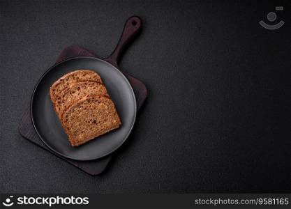 Delicious fresh crispy brown bread with grains and seeds on a dark concrete background