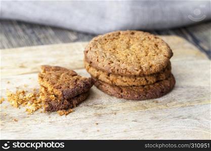 Delicious fresh crunchy oatmeal cookies, one of the biscuits on the broken crumbled. colored cookies