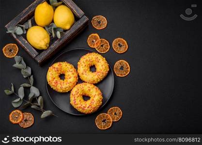 Delicious fresh donuts in yellow glaze with lemon flavor filling on textured concrete background