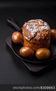 Delicious fresh Easter cake with fruits and raisins on a dark concrete background