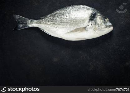 Delicious fresh fish on dark vintage background